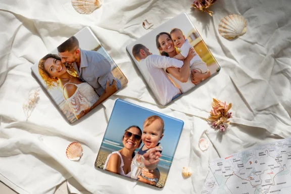 Three custom photo magnets of a couple, a baby, and a father holding a baby, displayed on a map of Mauritius with seashells scattered around.